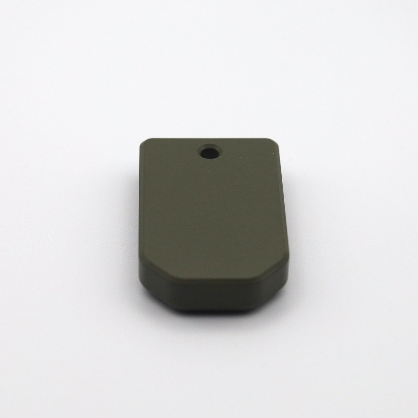 Close-up of green base plate for PSA Micro Dagger magazines, precision-machined for performance.