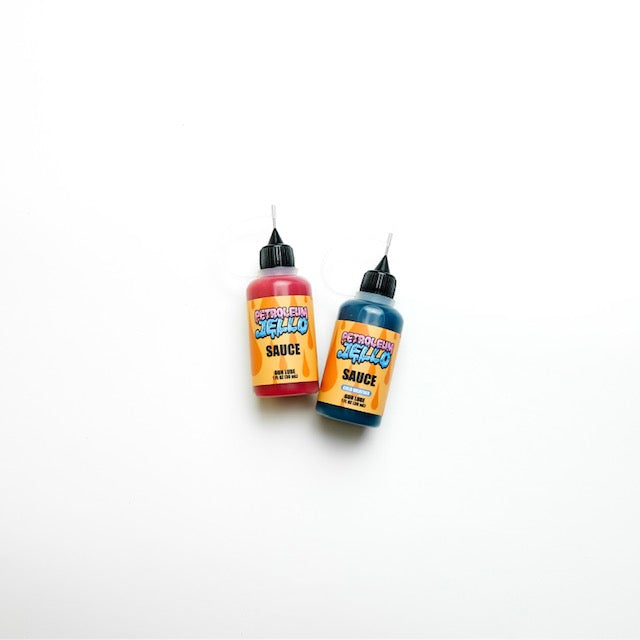 BLUE SAUCE and RED SAUCE bottles - firearm lubricants with precision nozzles for controlled and efficient application